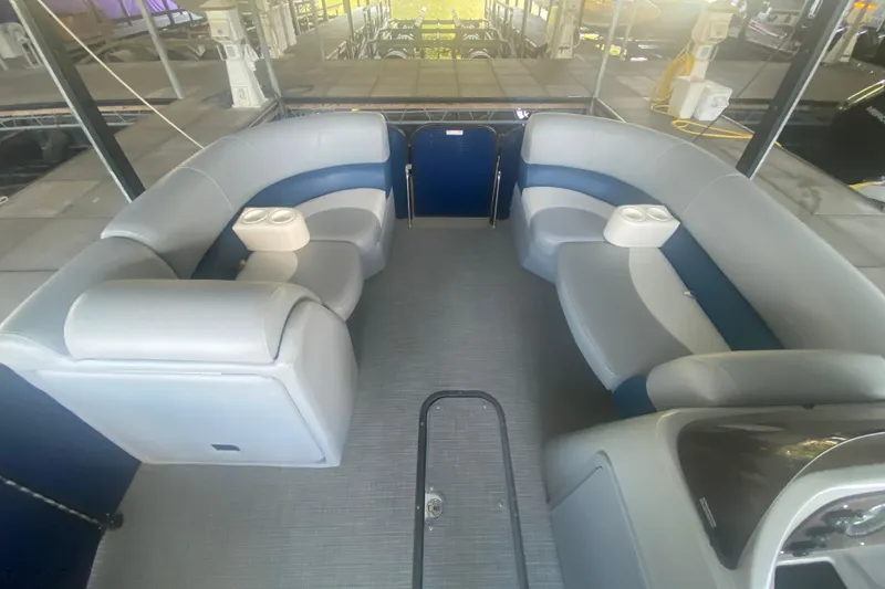Slide: The Image of 2019 Manitou Aurora LE 23 RF VP pontoon boat interior with gray seating and cup holders. - 9