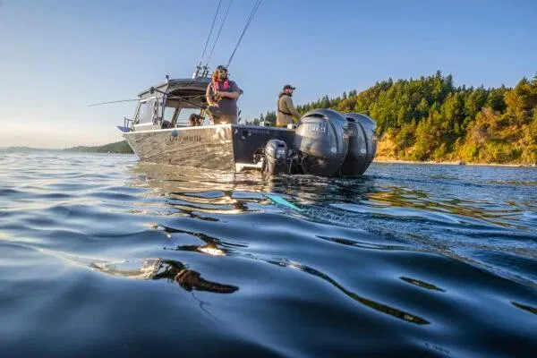 Slide: The Image of 2026 Duckworth 26 Pacific Pro boat on scenic water near forested shoreline. - 2