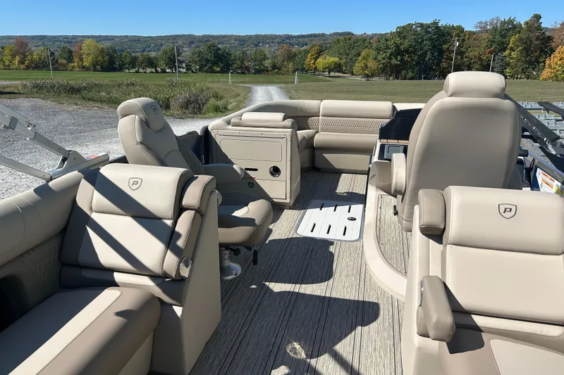 Slide: The Image of 2026 Premier 230 Solaris RF boat interior with beige seating and scenic outdoor view. - 11