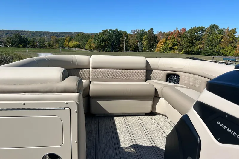 Slide: The Image of Luxurious interior of 2026 Premier 230 Solaris RF boat with beige seating and scenic background. - 12