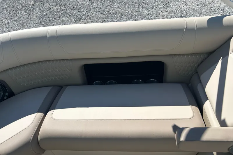 Slide: The Image of 2026 Premier 230 Solaris RF boat interior with beige seating and cup holders. - 23