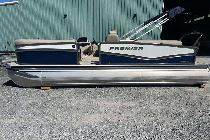 Slide: The Image of 2026 Premier 230 Solaris RF pontoon boat, side view, parked on gravel. - 3