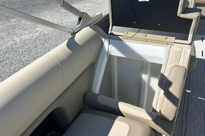 Slide: The Image of 2026 Premier 230 Solaris RF boat with open storage compartment and beige seating. - 32