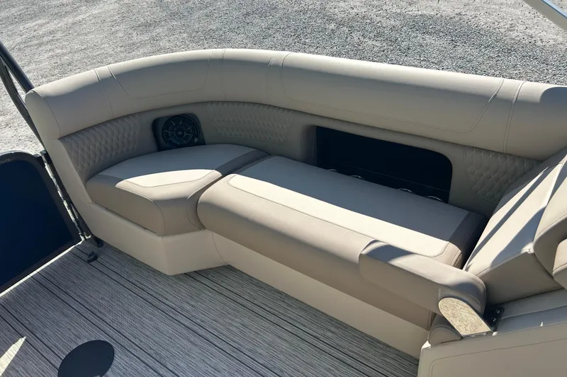 Slide: The Image of 2026 Premier 230 Solaris RF boat interior with beige seating and speaker. - 35