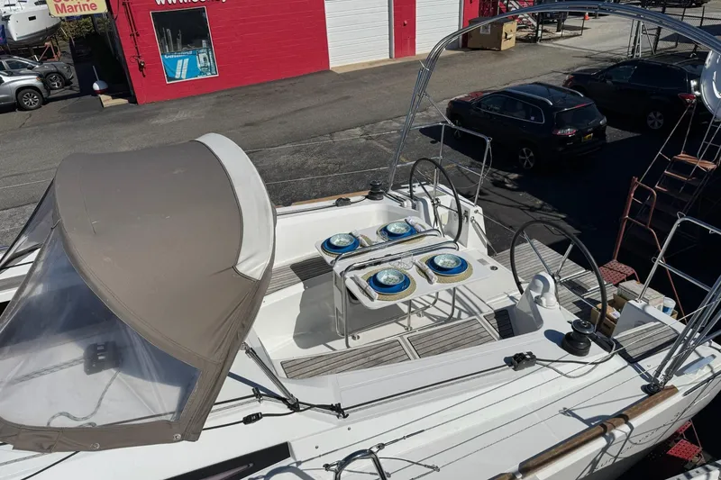 Slide: The Image of 2020 Jeanneau Sun Odyssey 349 sailboat with covered cockpit, docked at a marina. - 11