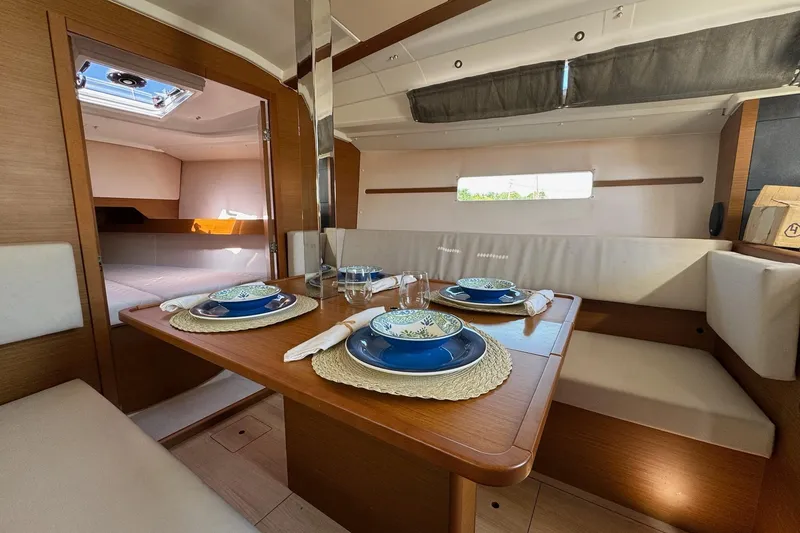 Slide: The Image of Interior of 2020 Jeanneau Sun Odyssey 349 yacht with elegant dining setup. - 23