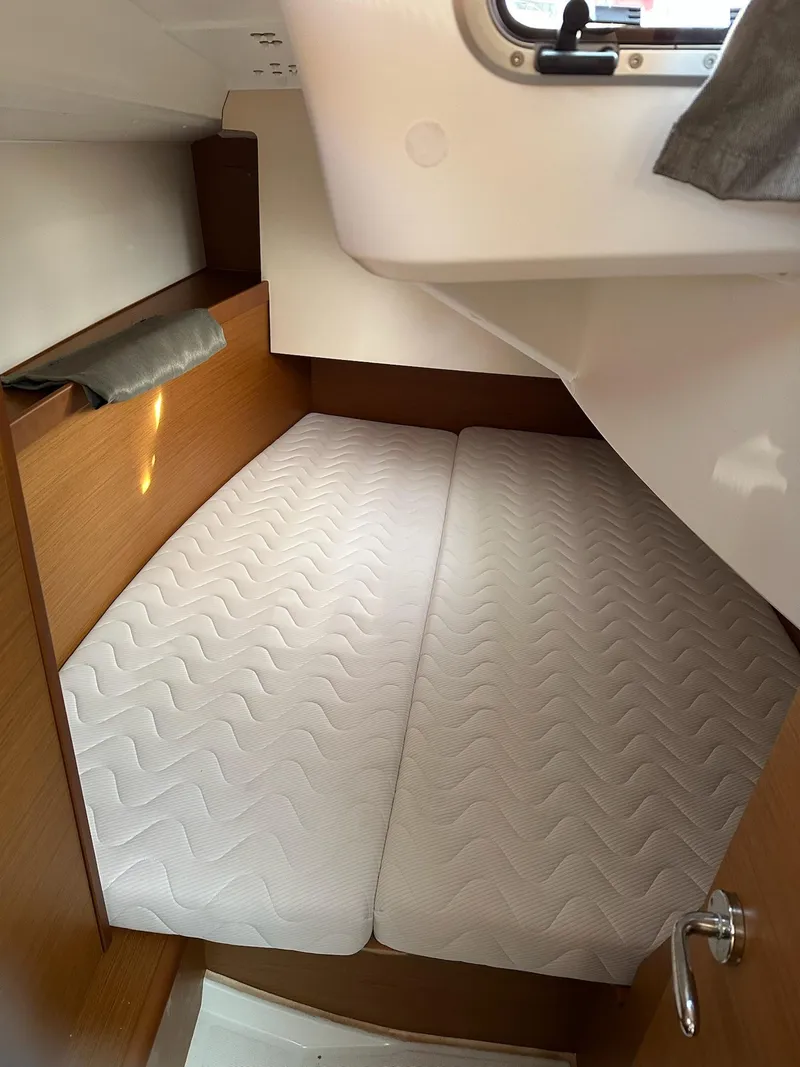 Slide: The Image of Cabin interior of 2020 Jeanneau Sun Odyssey 349 with twin beds and wooden finish. - 27