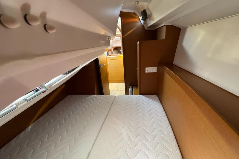 Slide: The Image of Cozy cabin interior of 2020 Jeanneau Sun Odyssey 349 sailboat with comfortable bedding. - 28