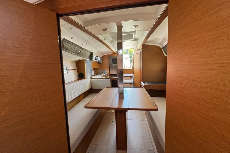 Slide: The Image of Interior of 2020 Jeanneau Sun Odyssey 349 sailboat, featuring wood finishes and seating area. - 33