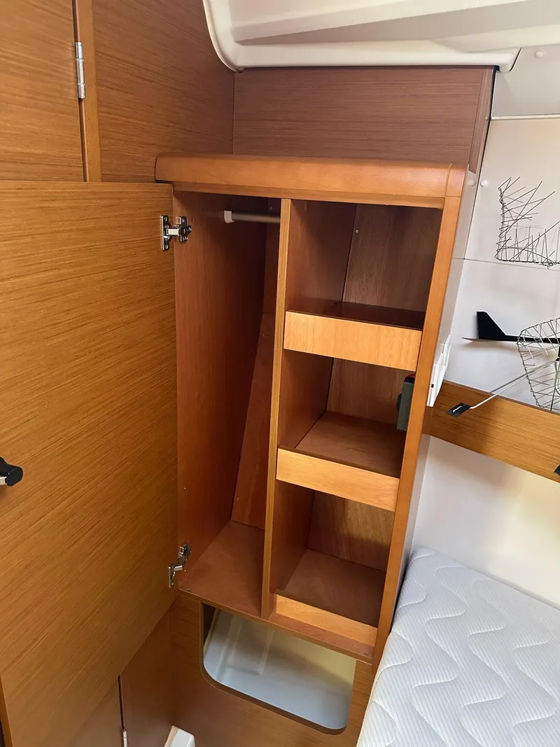 Slide: The Image of Interior storage of 2020 Jeanneau Sun Odyssey 349 sailboat with wooden shelves and cabinetry. - 35