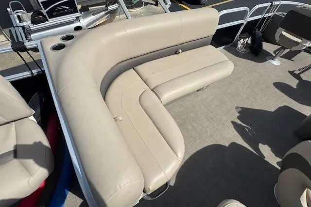 Slide: The Image of 2022 Sun Tracker Bass Buggy 18 DLX pontoon boat with beige seating and cup holders. - 11