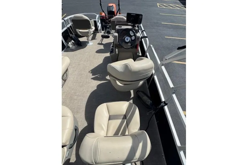 Slide: The Image of 2022 Sun Tracker Bass Buggy 18 DLX interior with beige seating and steering console. - 13