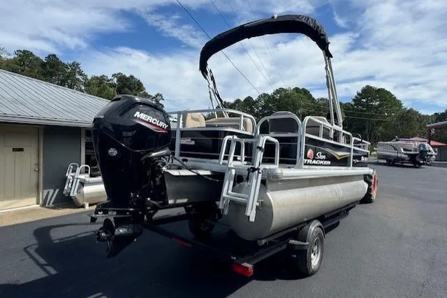 Slide: The Image of 2022 Sun Tracker Bass Buggy 18 DLX pontoon boat with Mercury engine on trailer. - 3