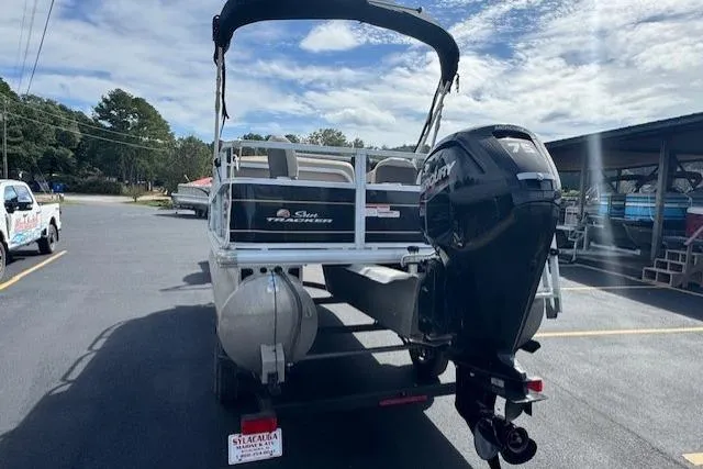 Slide: The Image of 2022 Sun Tracker Bass Buggy 18 DLX pontoon boat with Mercury outboard motor in parking lot. - 4