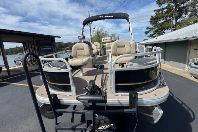 Slide: The Image of 2022 Sun Tracker Bass Buggy 18 DLX pontoon boat with seating, docked near a lake. - 7