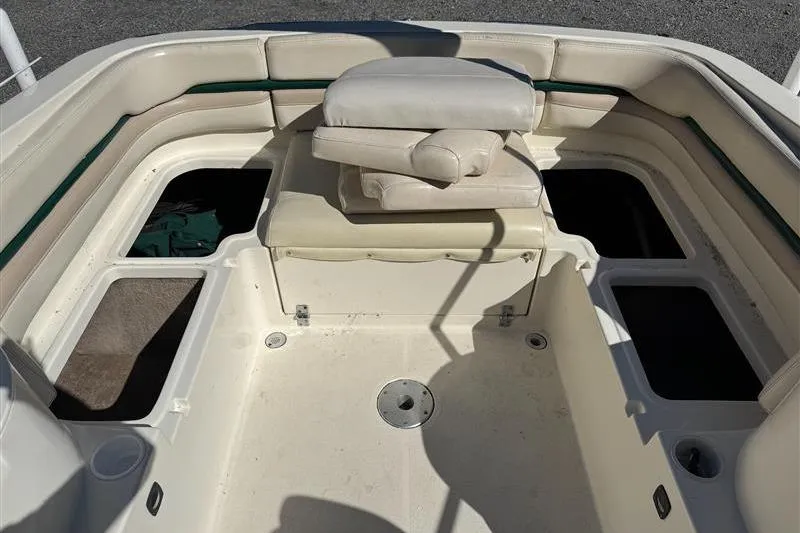 Slide: The Image of 2001 Stingray 240 LS boat interior with seating and storage compartments. - 16