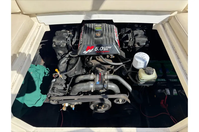 Slide: The Image of Engine compartment of a 2001 Stingray 240 LS boat, featuring a 5.0 Litre EFI engine. - 17
