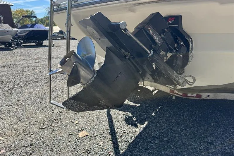 Slide: The Image of 2001 Stingray 240 LS boat with MerCruiser outdrive, parked on gravel lot. - 21