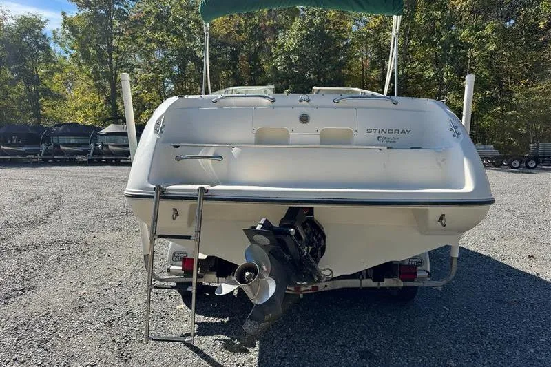 Slide: The Image of Rear view of a 2001 Stingray 240 LS boat with outboard motor. - 22