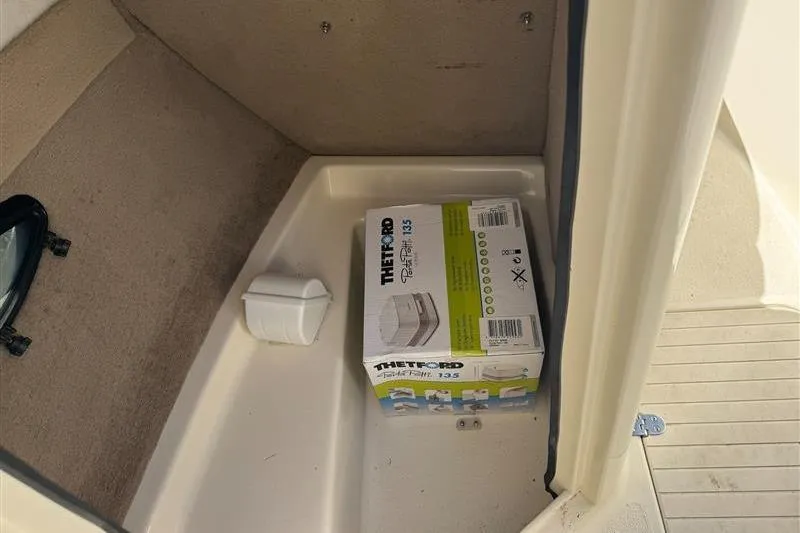 Slide: The Image of Box of Thetford Porta Potti in 2001 Stingray 240 LS boat compartment. - 27