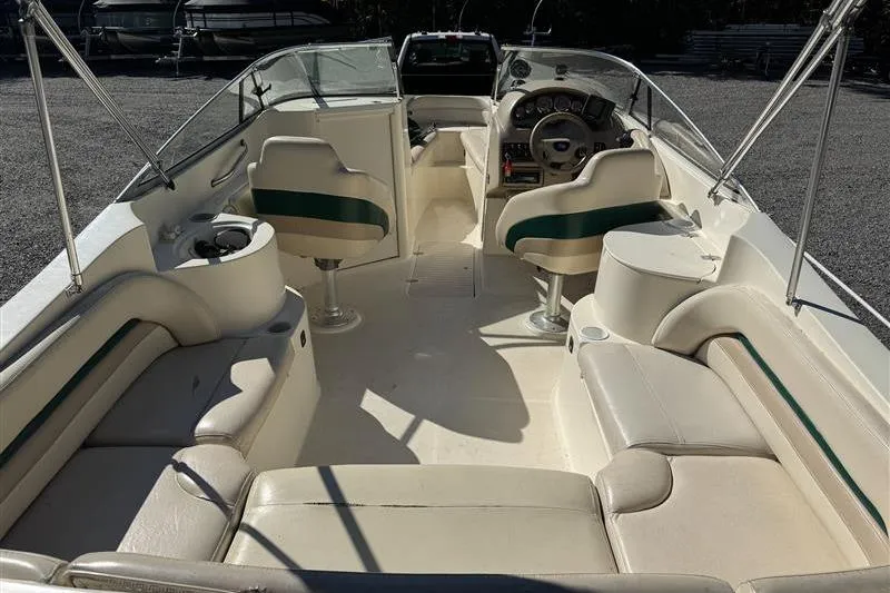 Slide: The Image of 2001 Stingray 240 LS boat interior with seating and steering console. - 28