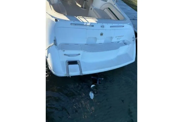 Slide: The Image of 2001 Stingray 240 LS boat rear view with swim platform and ladder. - 6