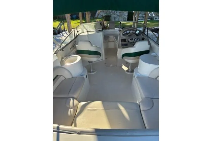 Slide: The Image of Interior view of a 2001 Stingray 240 LS boat with seating and steering console. - 7