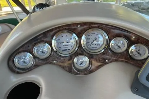 Slide: The Image of Dashboard of a 2001 Stingray 240 LS boat with multiple gauges and wood trim. - 8