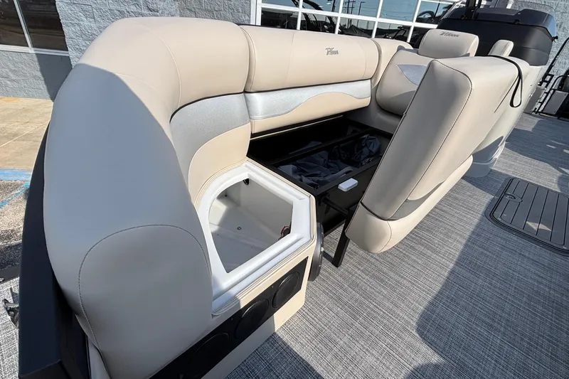 Slide: The Image of 2026 JC Neptoon 25TT Sport boat interior with open storage compartment and seating. - 11
