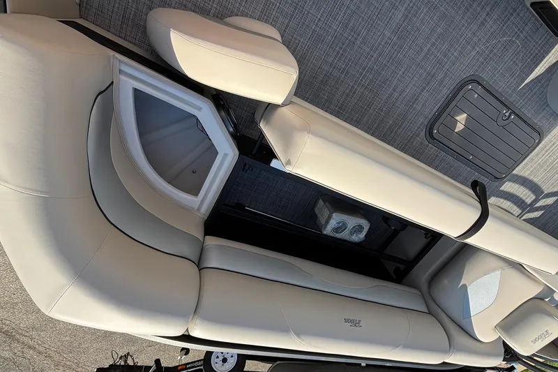 Slide: The Image of Interior view of 2026 JC Neptoon 25TT Sport boat with beige seating and storage compartments. - 12