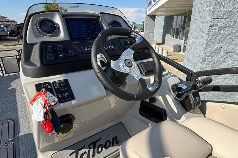 Slide: The Image of Steering console of 2026 JC Neptoon 25TT Sport boat with modern controls and dashboard. - 18