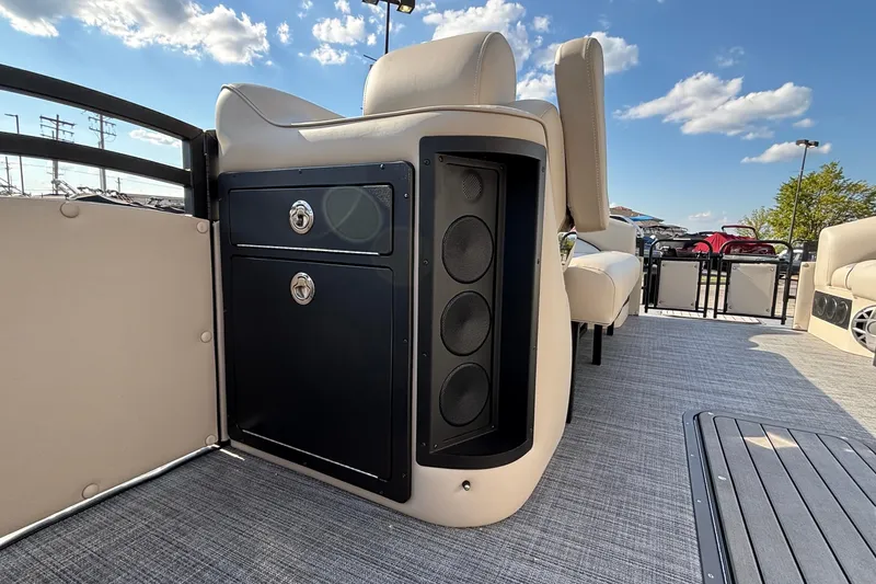 Slide: The Image of 2026 JC Neptoon 25TT Sport boat interior with seating and storage, under a clear blue sky. - 14