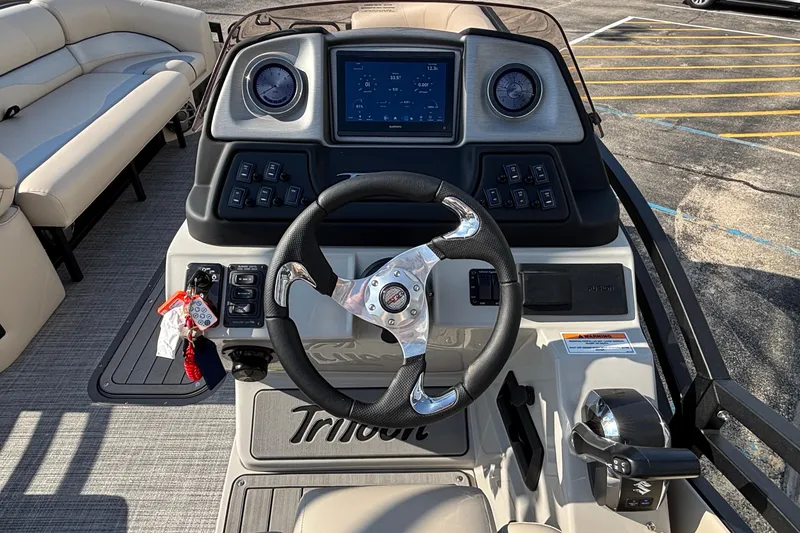 Slide: The Image of 2026 JC Neptoon 25TT Sport boat dashboard with steering wheel and control panel. - 21