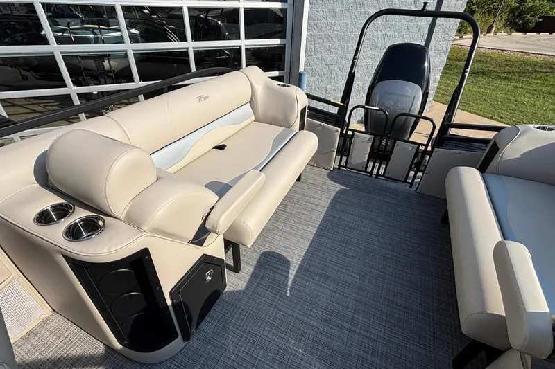Slide: The Image of 2026 JC Neptoon 25TT Sport boat interior with beige seating and cup holders. - 25
