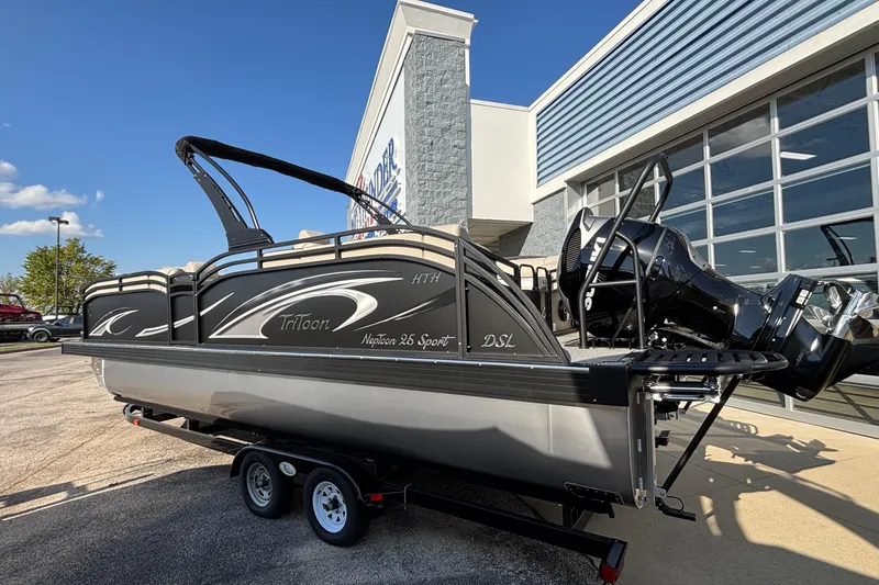 Slide: The Image of 2026 JC Neptoon 25TT Sport pontoon boat on trailer outside dealership. - 3