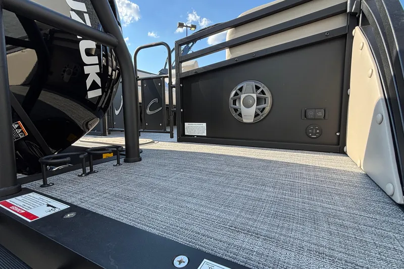 Slide: The Image of 2026 JC Neptoon 25TT Sport boat deck with speaker and Suzuki engine detail. - 35