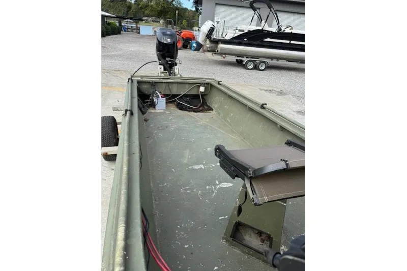 Slide: The Image of 2018 Encore Boat Works 18, interior view with motor and seating. - 7