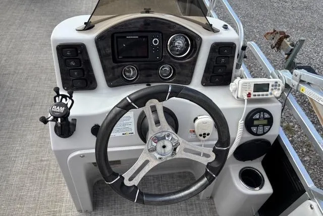 Slide: The Image of Steering console of 2021 Apex Marine 822 Angler Quest Family Fish boat with controls and gauges. - 8