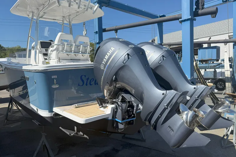 Slide: The Image of 2017 Regulator 25 boat with dual Yamaha outboard engines, docked in a marina. - 11