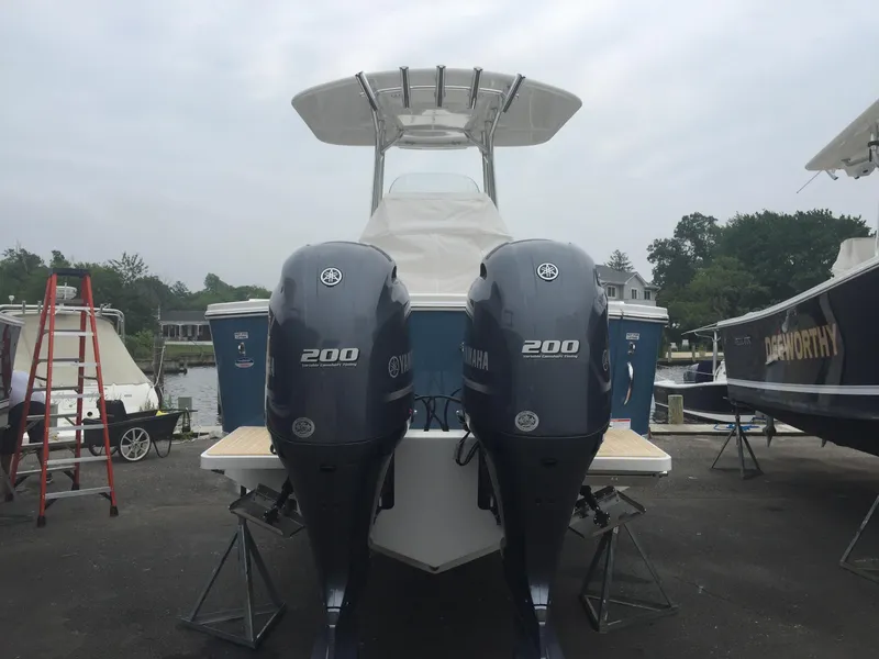 Slide: The Image of 2017 Regulator 25 boat with twin Yamaha 200 engines, docked outdoors. - 17
