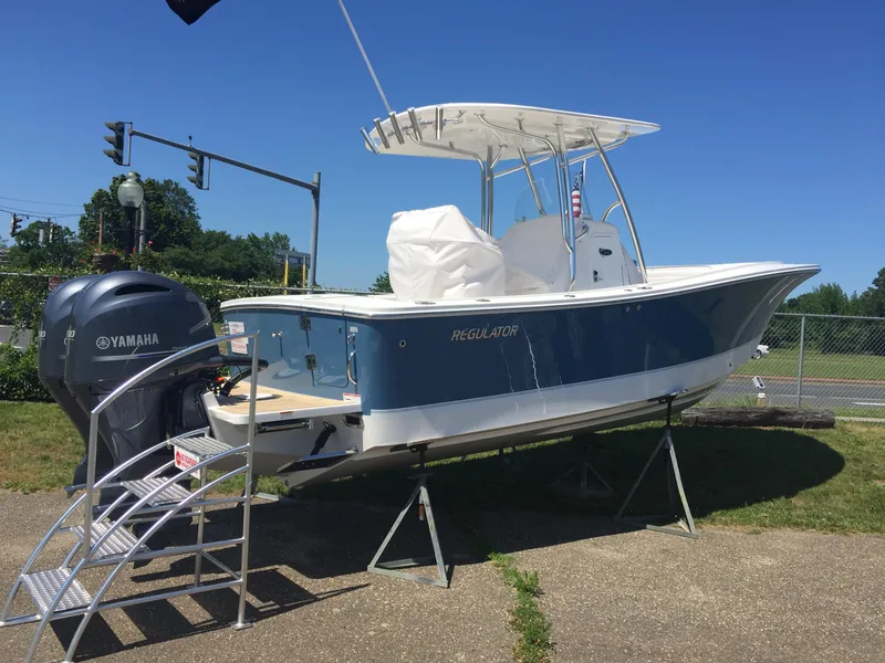 Slide: The Image of 2017 Regulator 25 boat with Yamaha engine on display outdoors. - 24