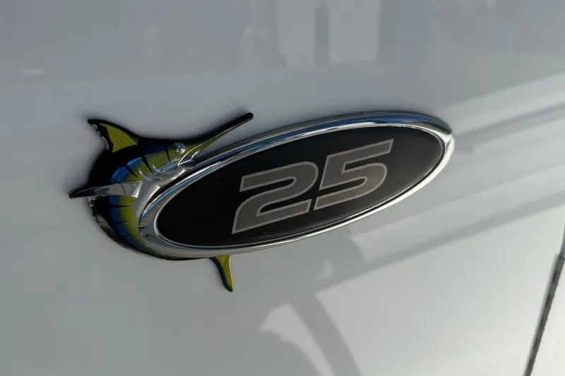 Slide: The Image of 2017 Regulator 25 emblem with marlin design on boat exterior. - 25
