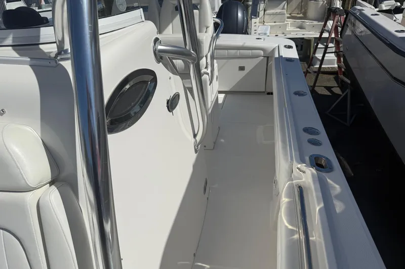 Slide: The Image of 2017 Regulator 25 boat interior with white seating and stainless steel fixtures. - 31