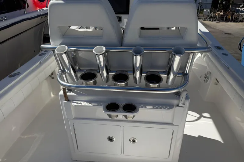 Slide: The Image of 2017 Regulator 25 boat interior with rod holders and storage compartments. - 33