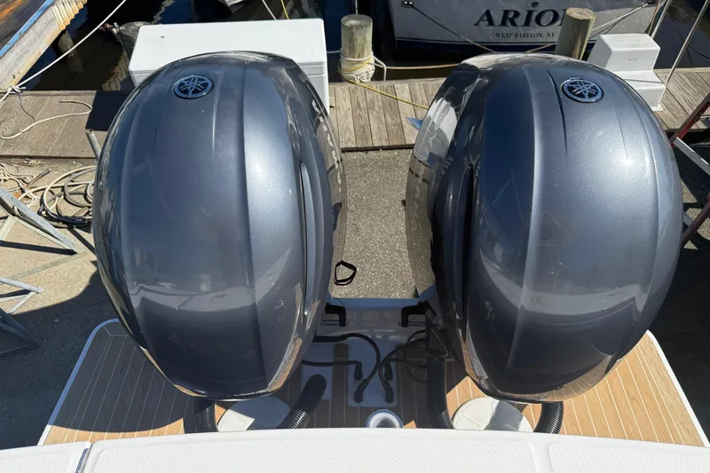 Slide: The Image of Twin Yamaha outboard engines on a 2017 Regulator 25 boat at a dock. - 35