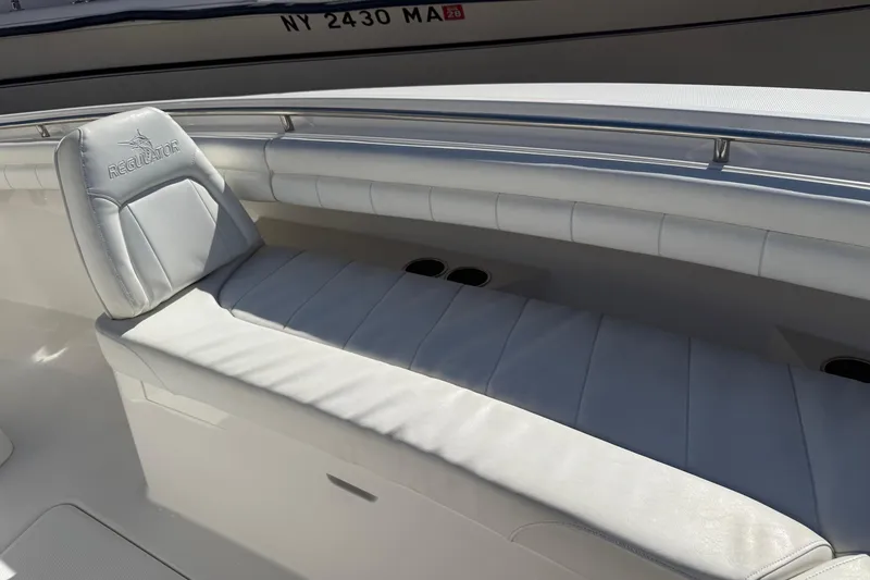 Slide: The Image of 2017 Regulator 25 boat interior with white cushioned seating and sleek design. - 40