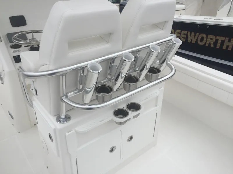 Slide: The Image of 2017 Regulator 25 boat interior with rod holders and storage compartments. - 5