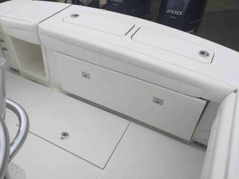 Slide: The Image of 2017 Regulator 25 boat interior with storage compartments and Yamaha 200 engines. - 6
