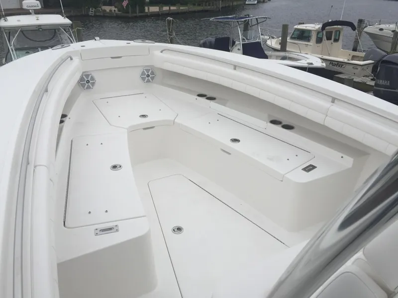 Slide: The Image of 2017 Regulator 25 boat with spacious seating and storage, docked at a marina. - 9