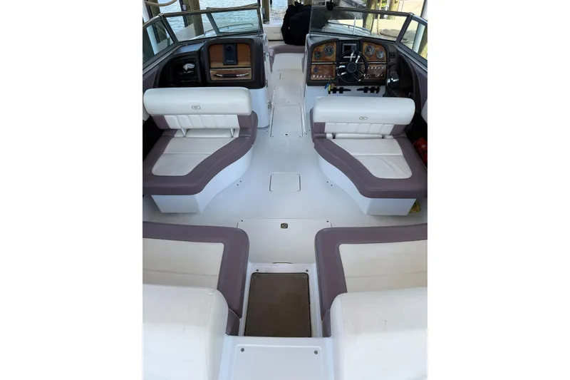 Slide: The Image of Interior of a 2010 Cobalt 296 boat with white and gray seating. - 14